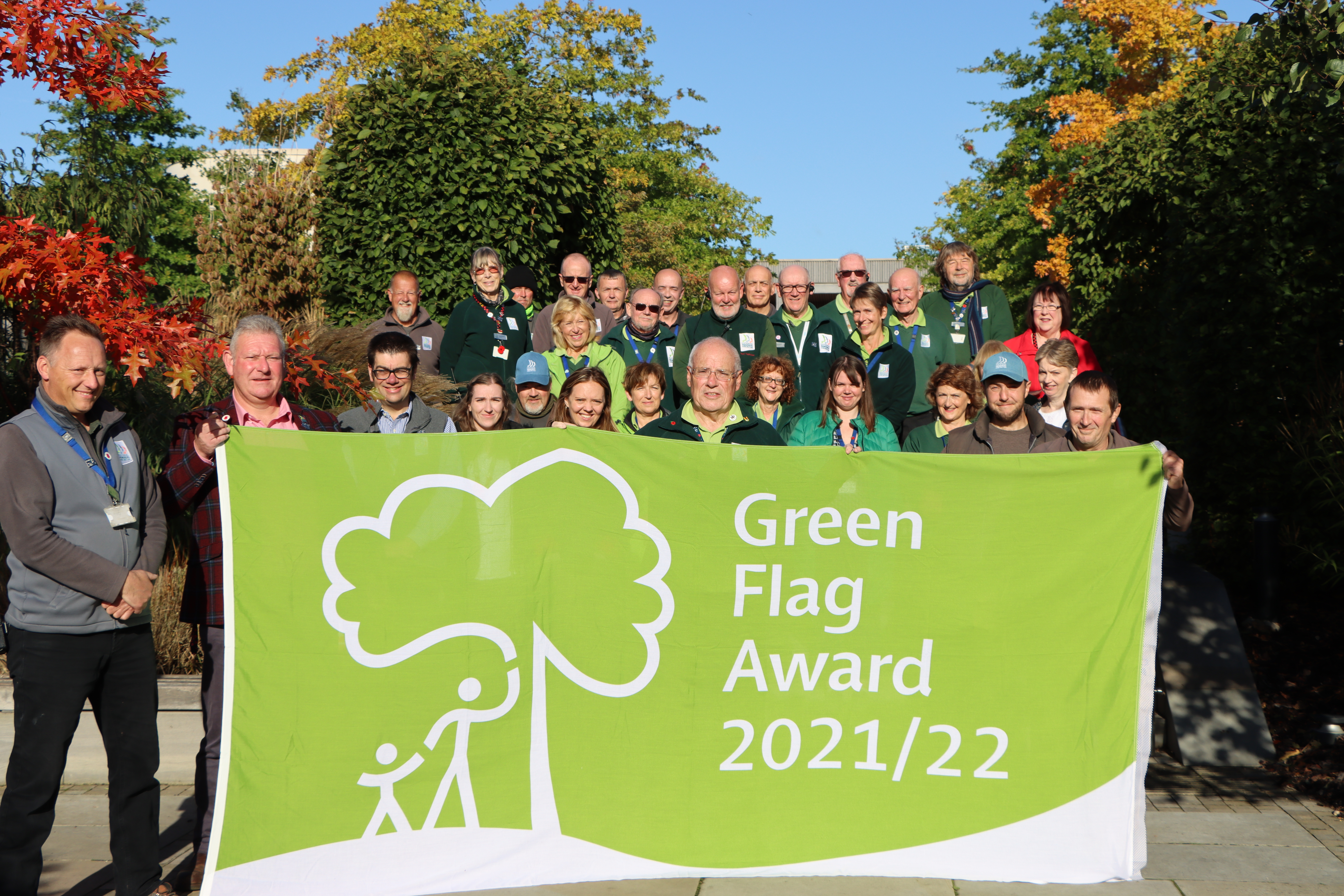 Arboretum Team holding the Green Flag
