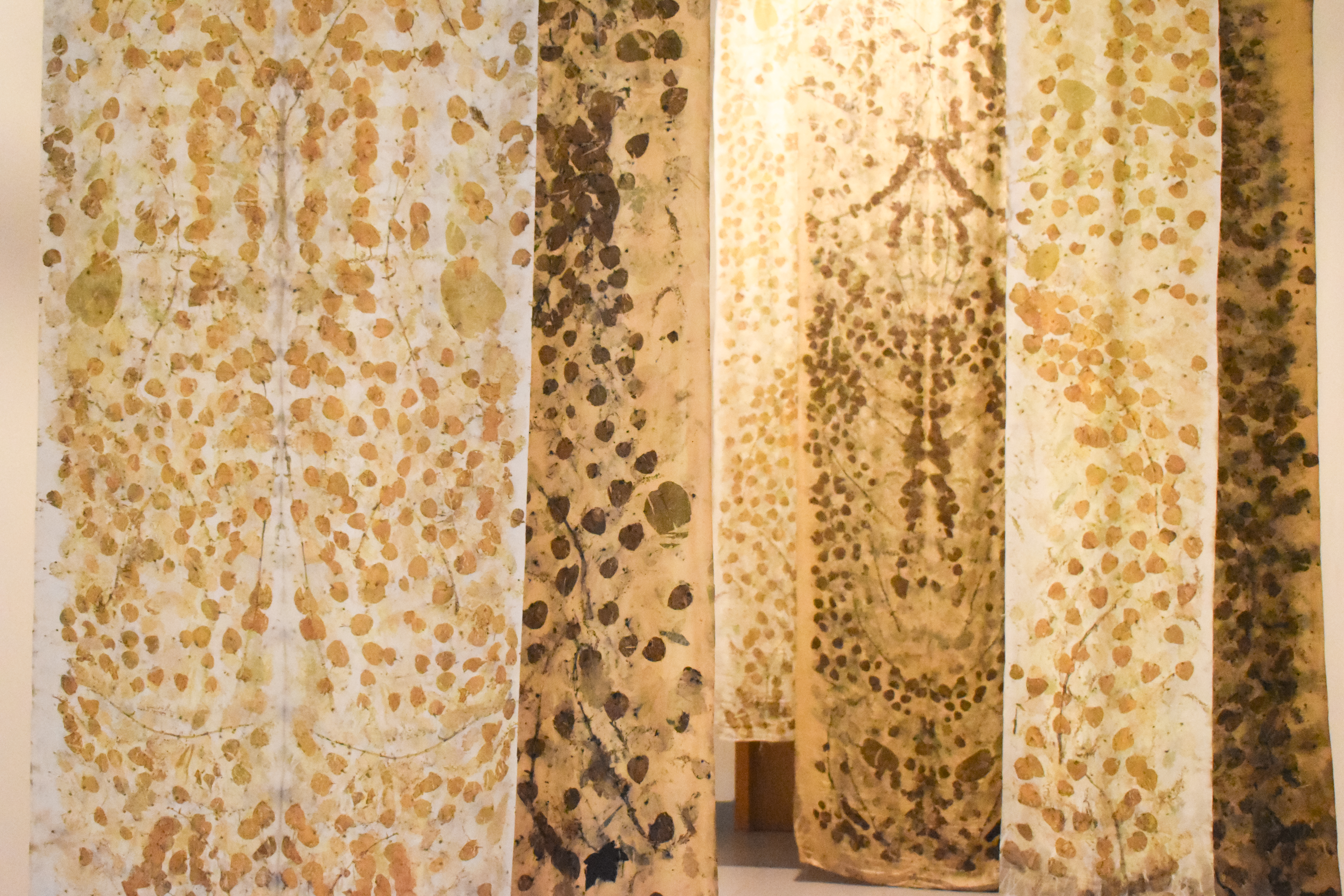 Hanging silk artworks from the Breaking Ground exhibition