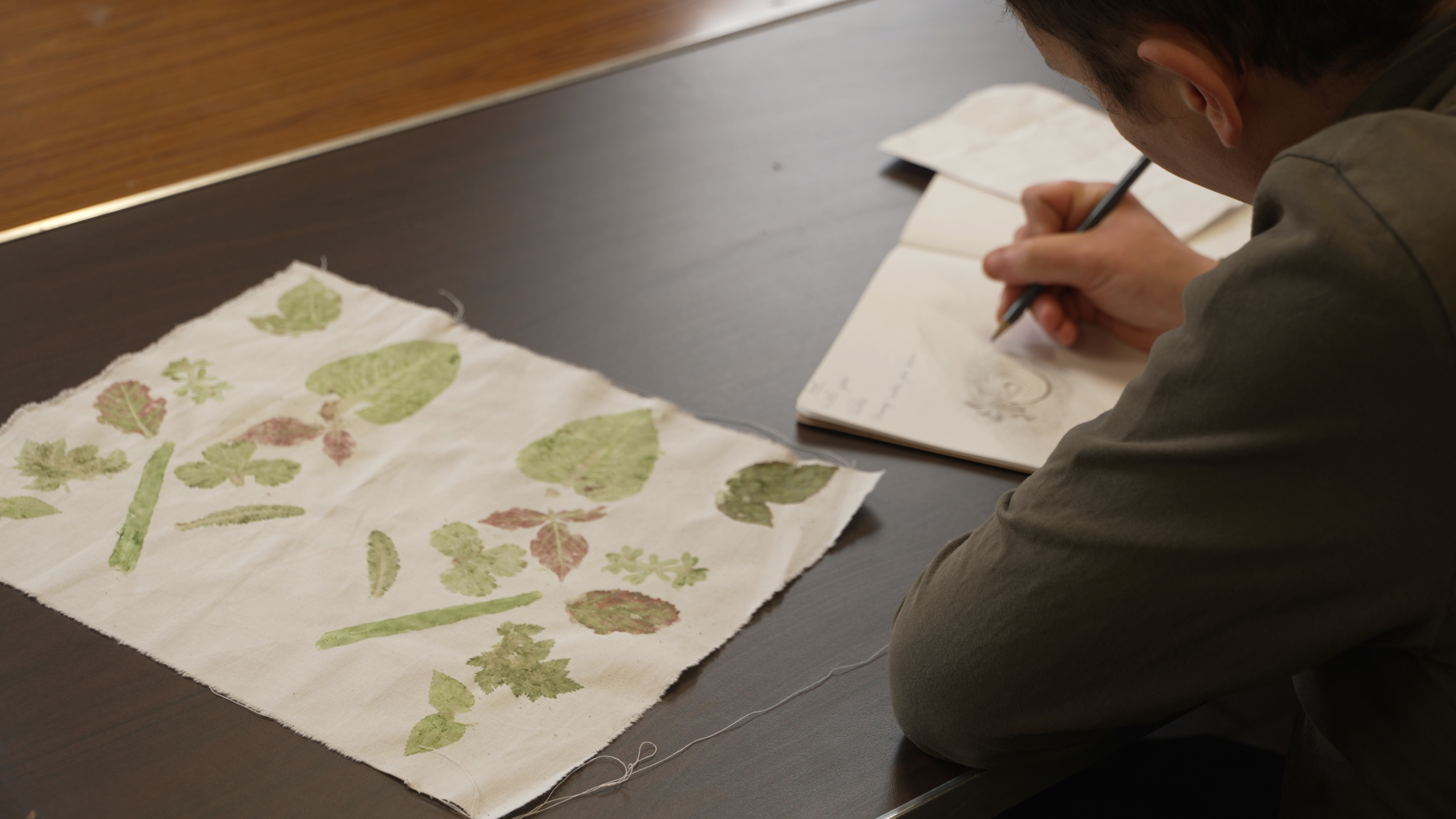 Artist drawing as part of the Breaking Ground Exhibition