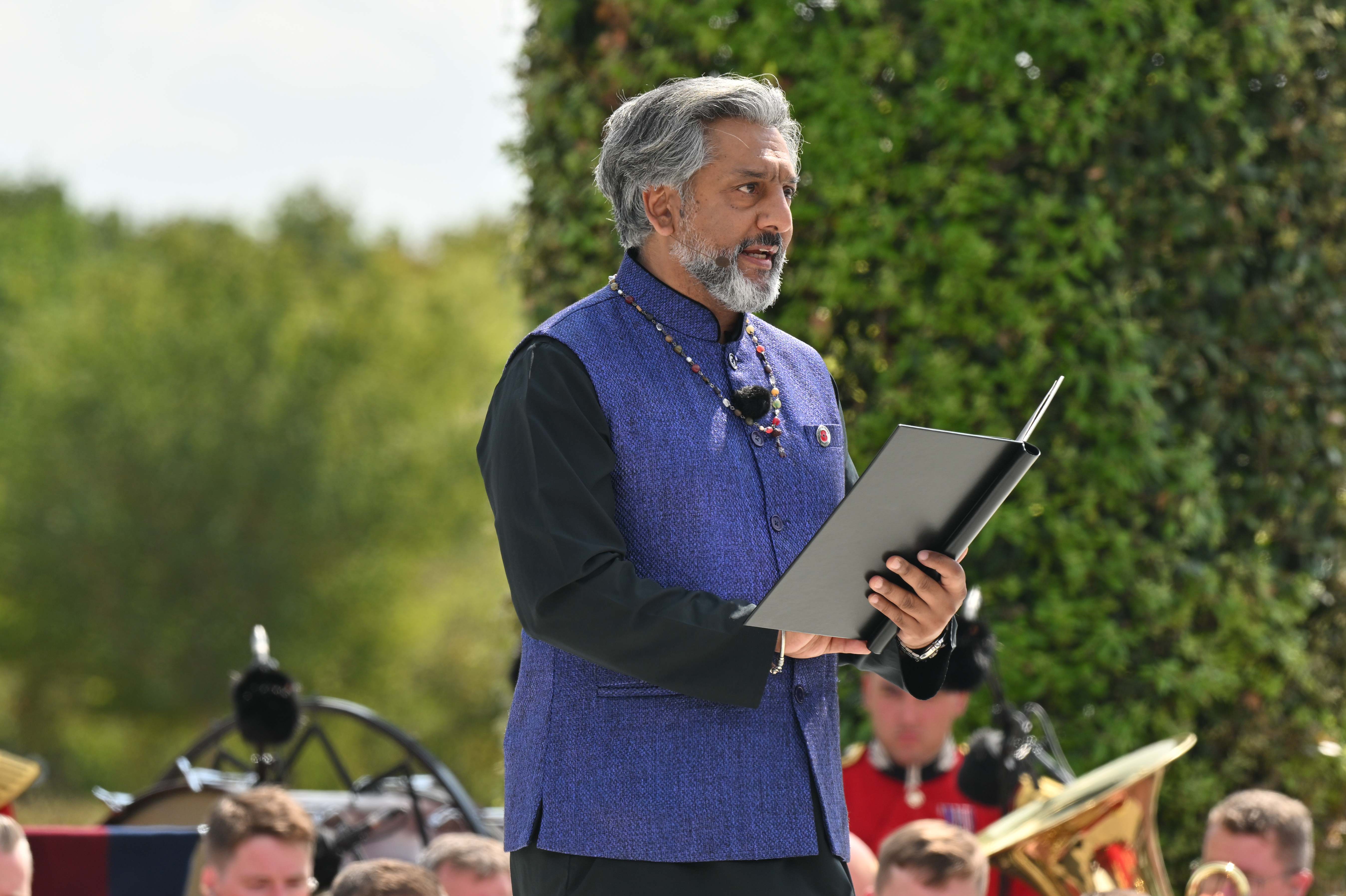 Nitin Ganatra reads the testimony of Mohammad Ghani during the VJ Day 80 service