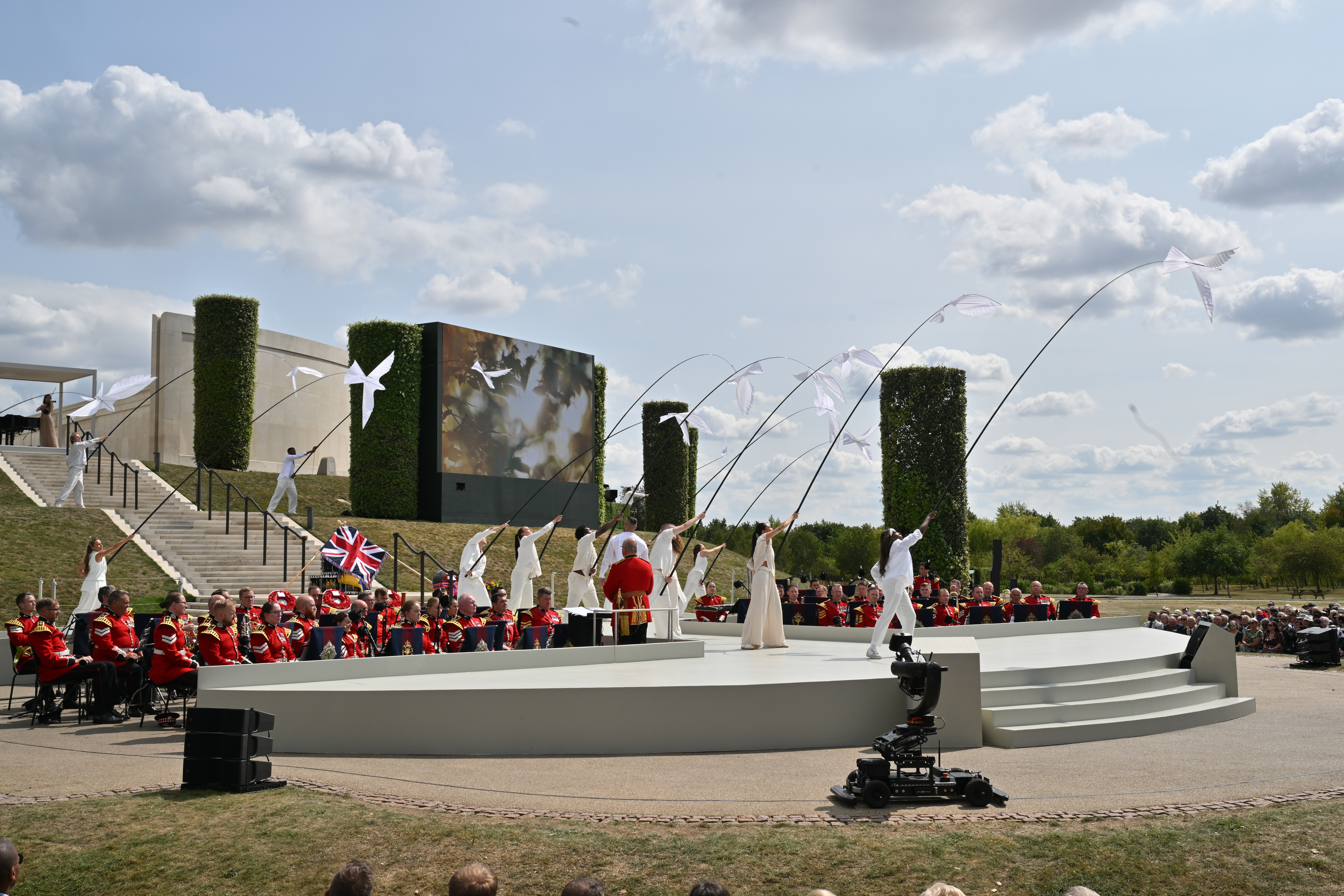 One of the musical performances during the service was accompanied by dancers with birds on large poles