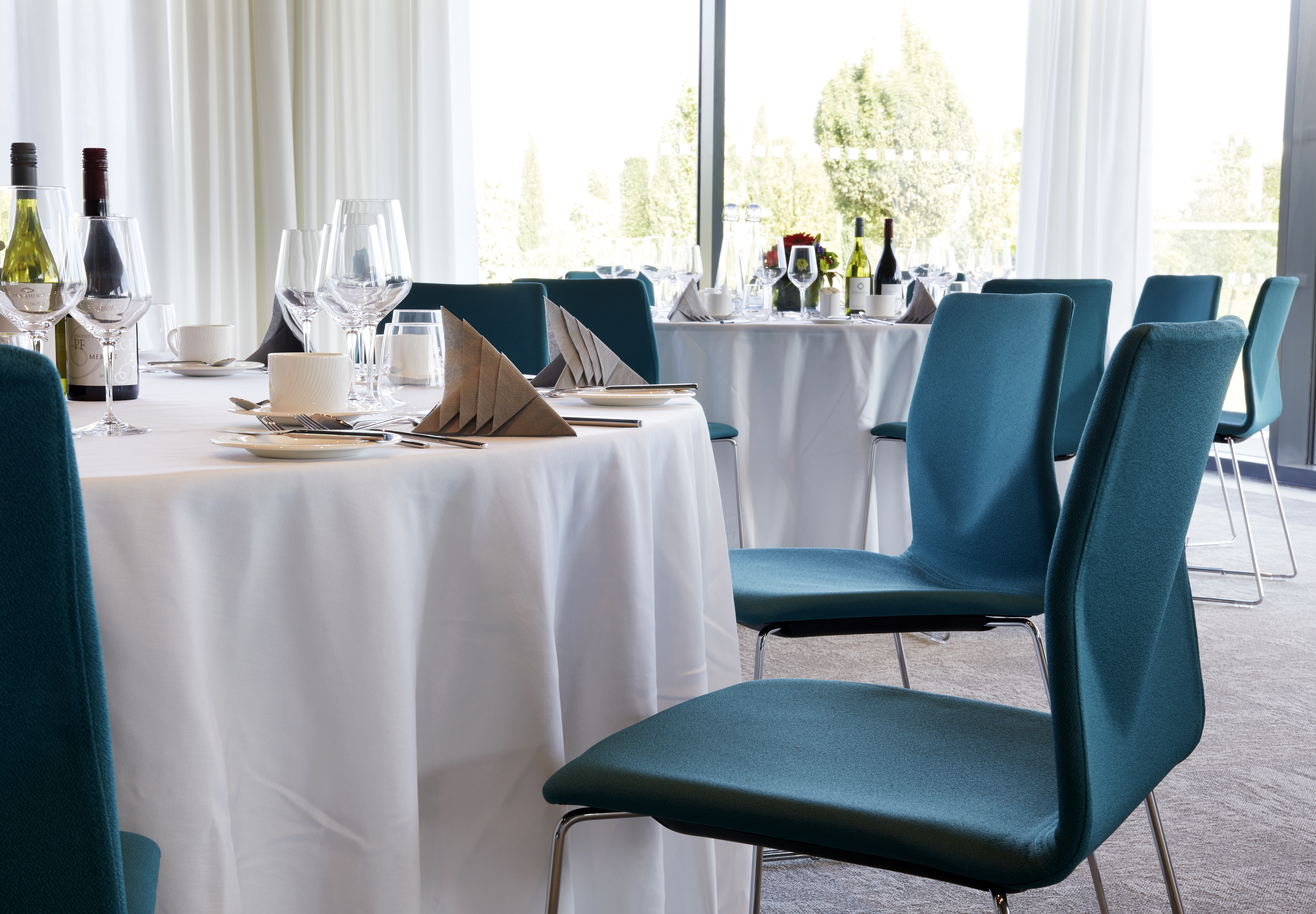 Tables in the Aspects Oak Suite laid up for a seated dinner
