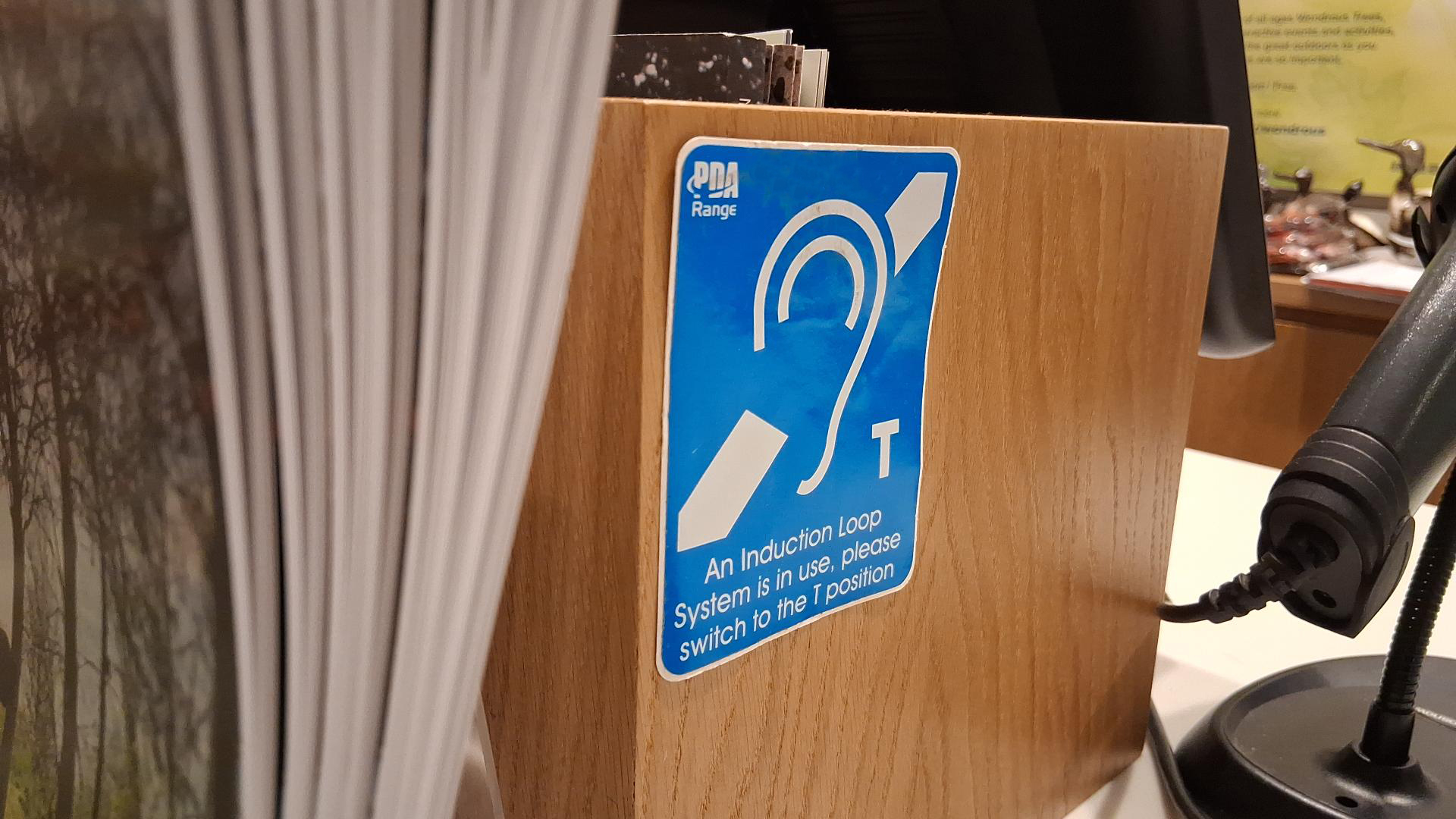 Blue hearing loop sticker located at the till in the shop