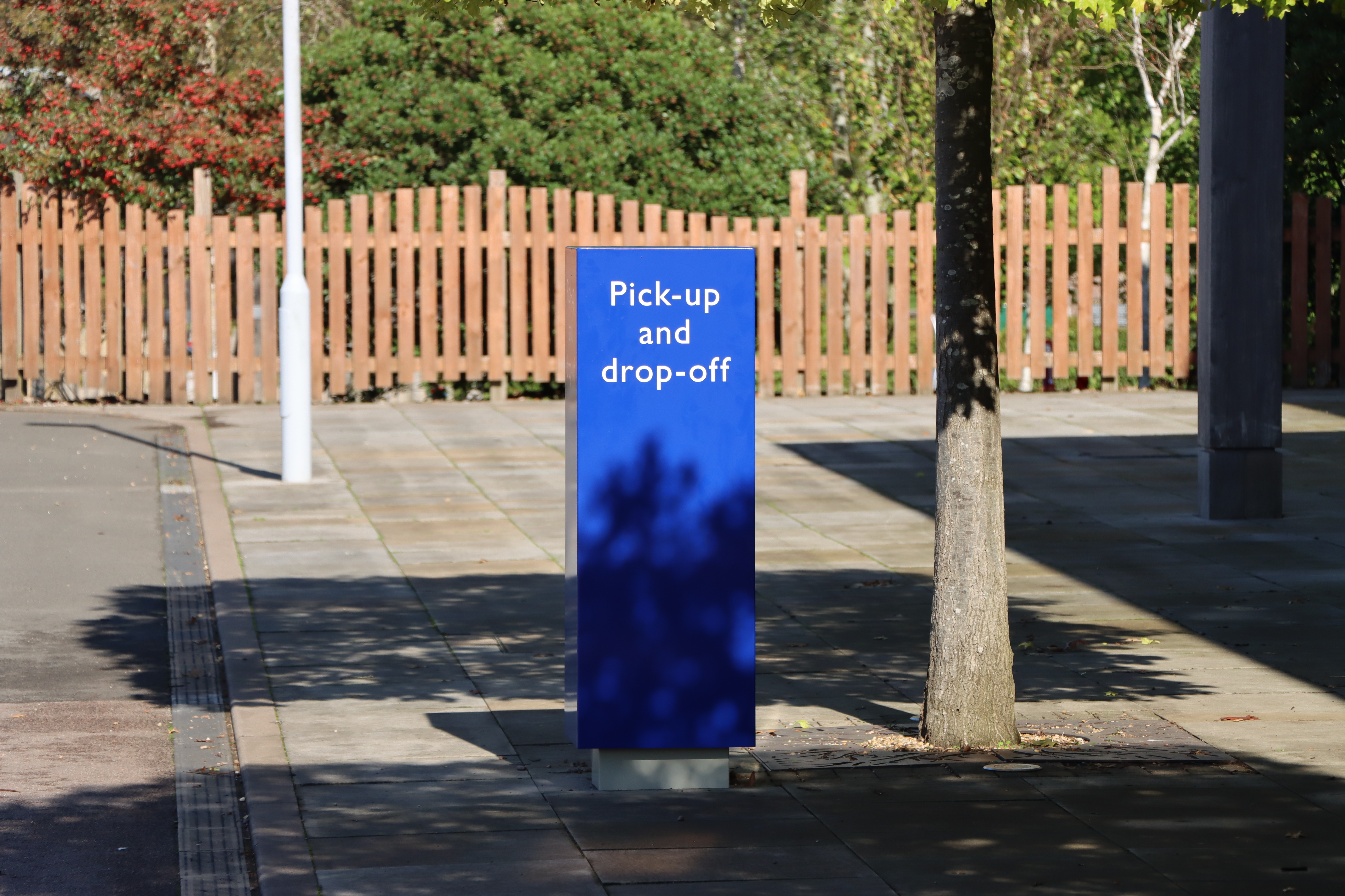 A blue sign highlighting the drop off area at the front of the Remembrance Centre