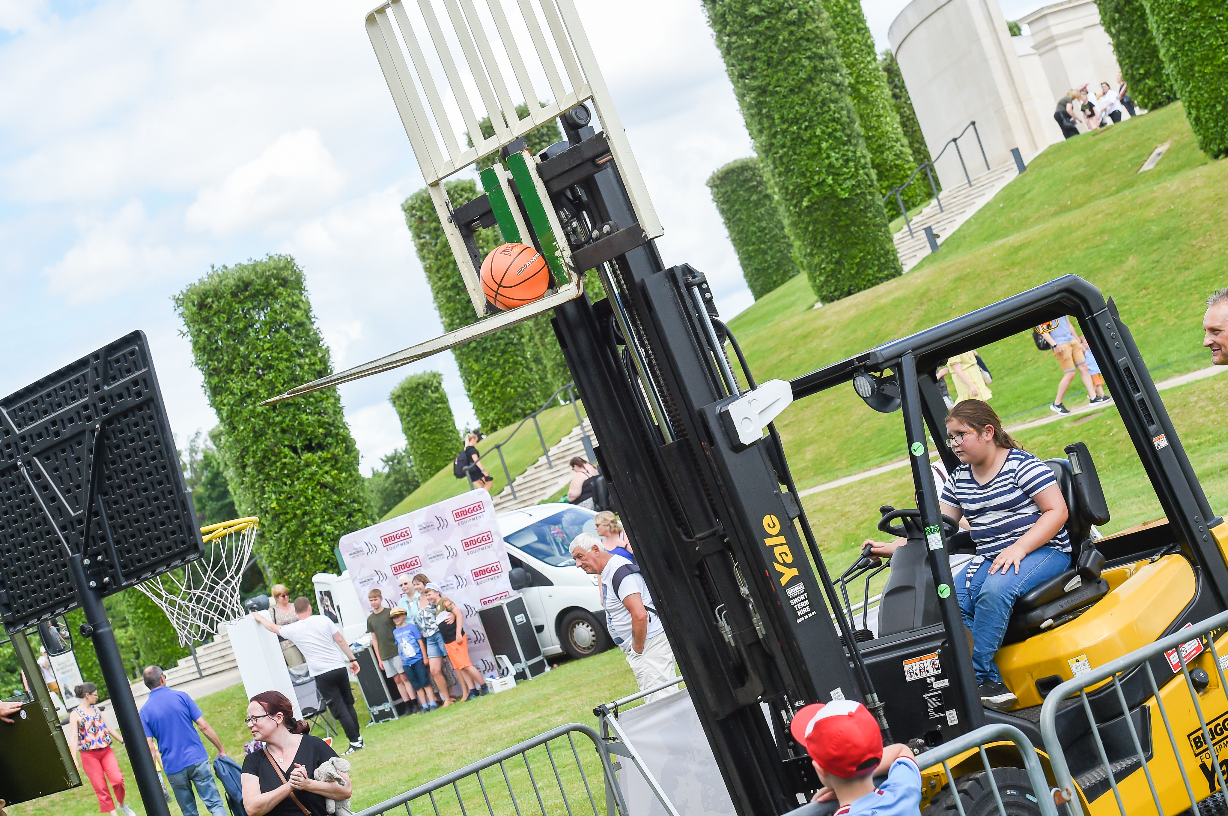 A young girl takes part in forklift basketball, an event run by Briggs at the Armed Forces Weekend event.