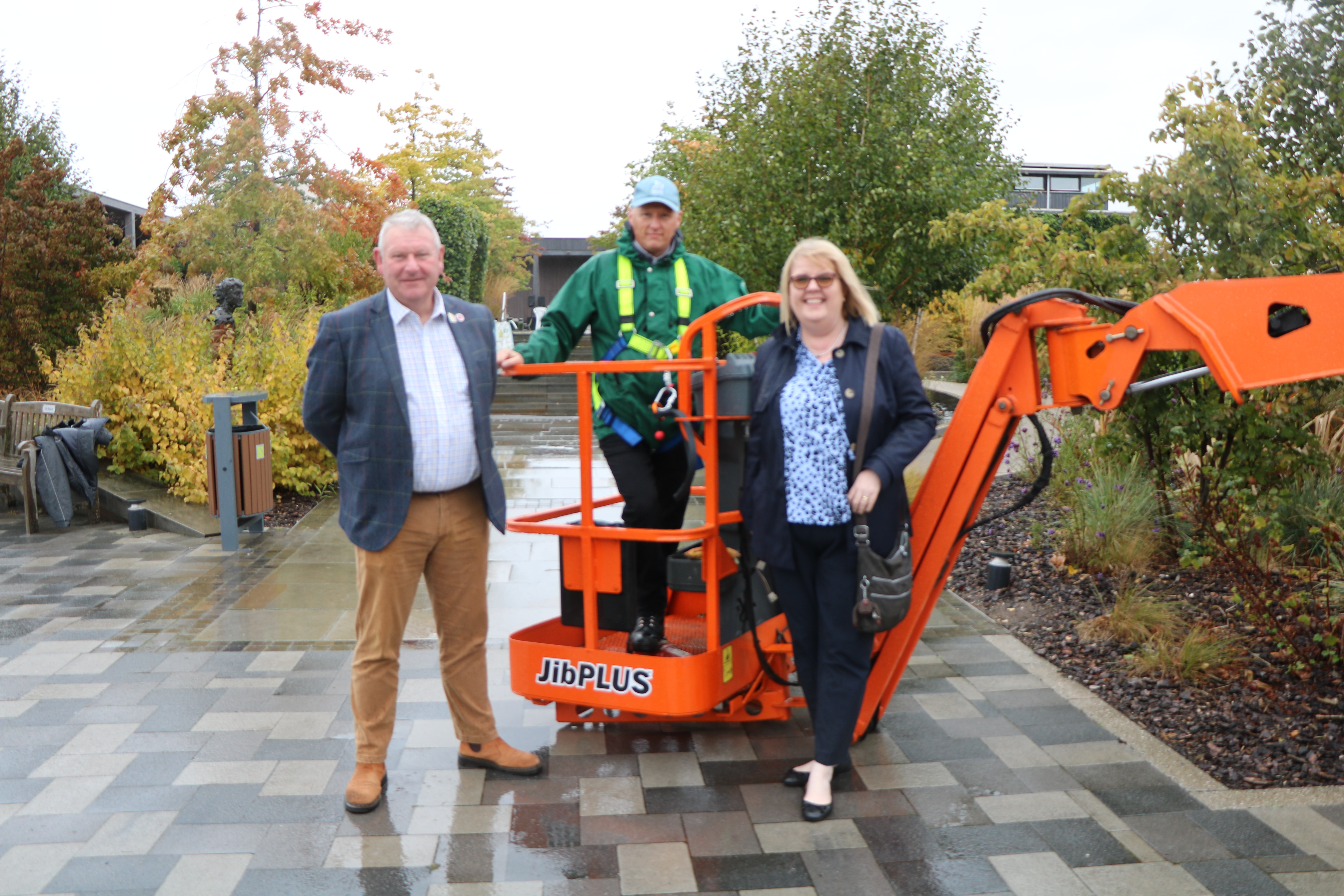 Briggs Equipment employee handing over the keys to a forklift, gifted for use to the Arboretum.