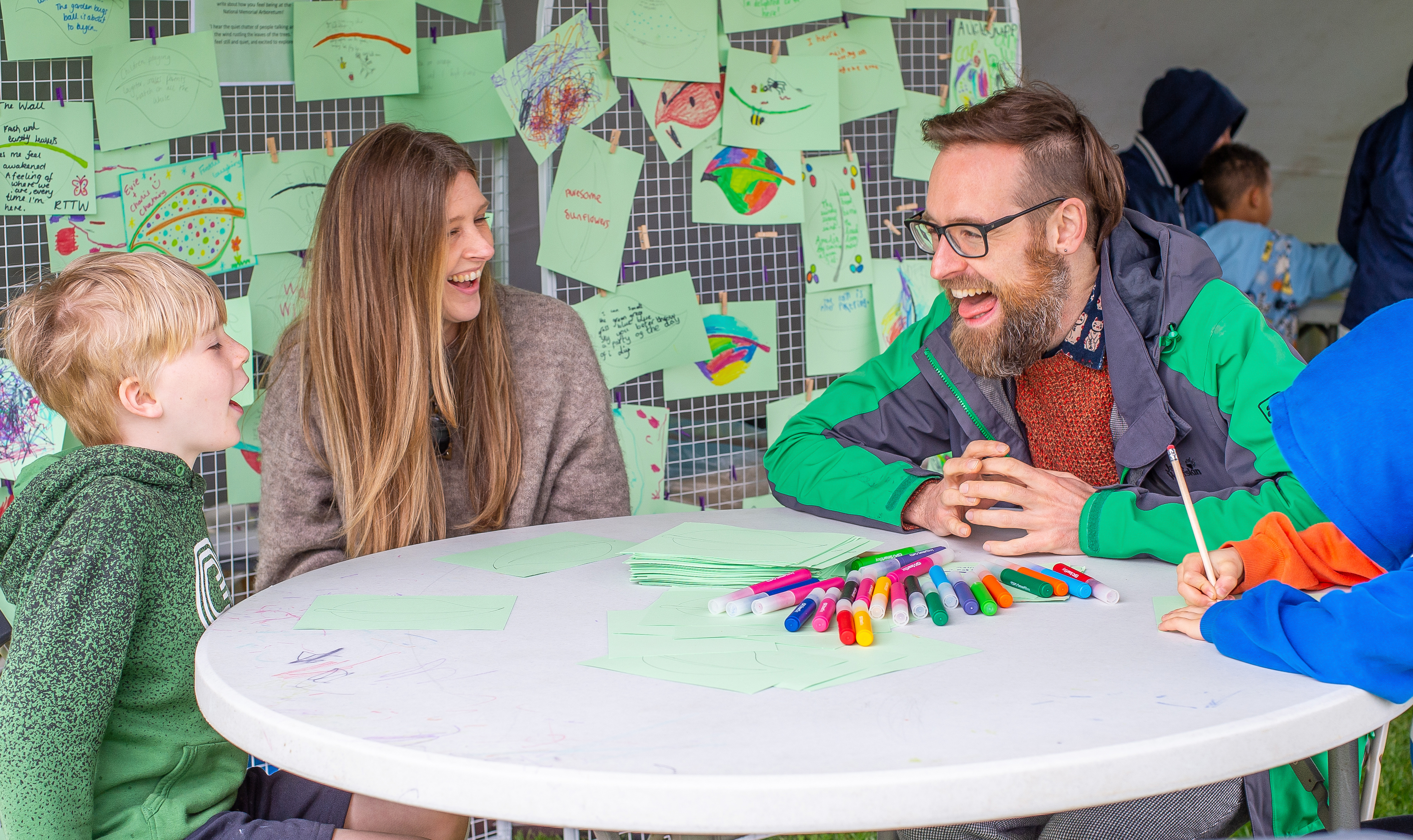 Dan Simpson, poet-in-residence, talking to a child at the Great Garden Party event in 2023