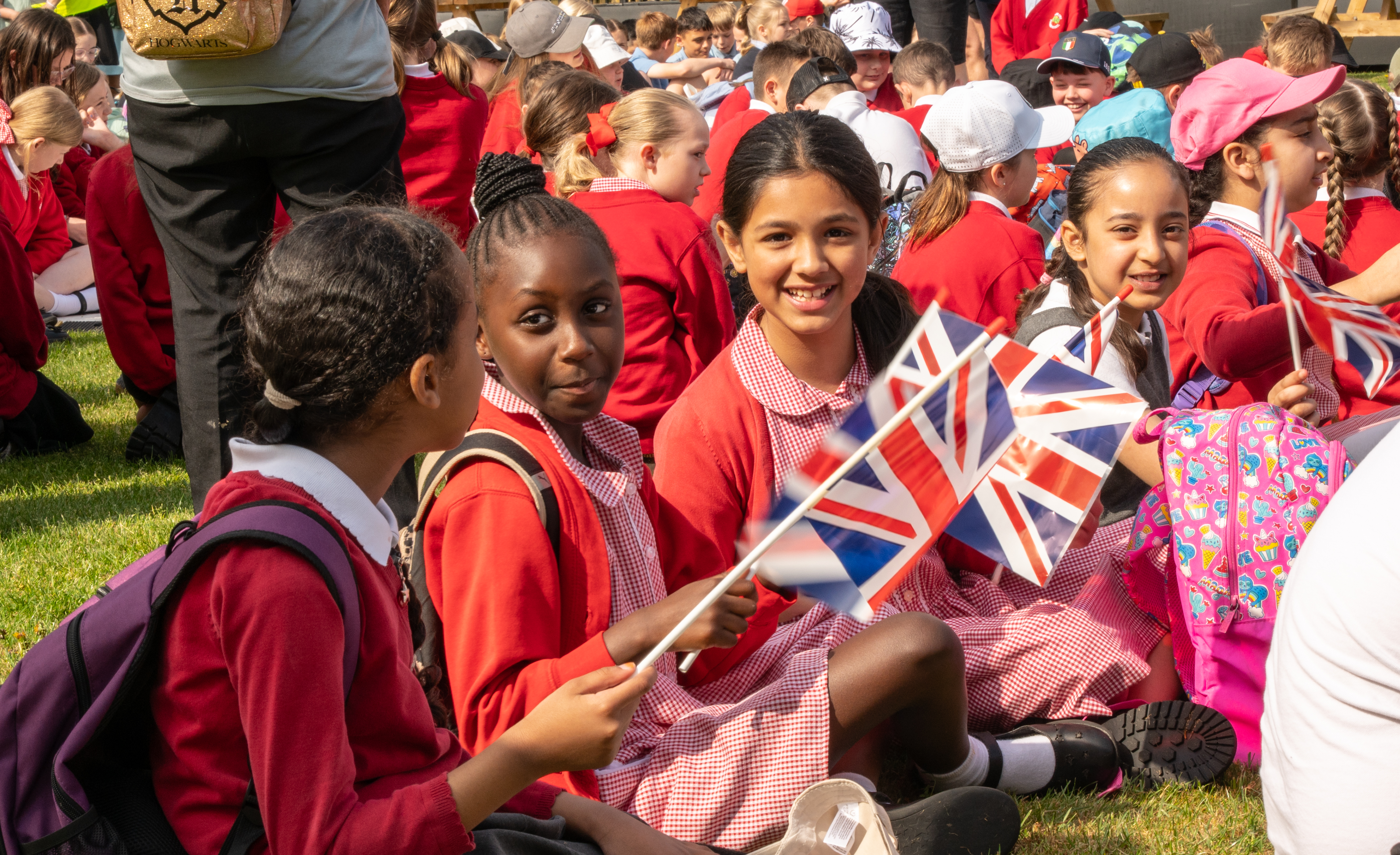School children waving union jack flags