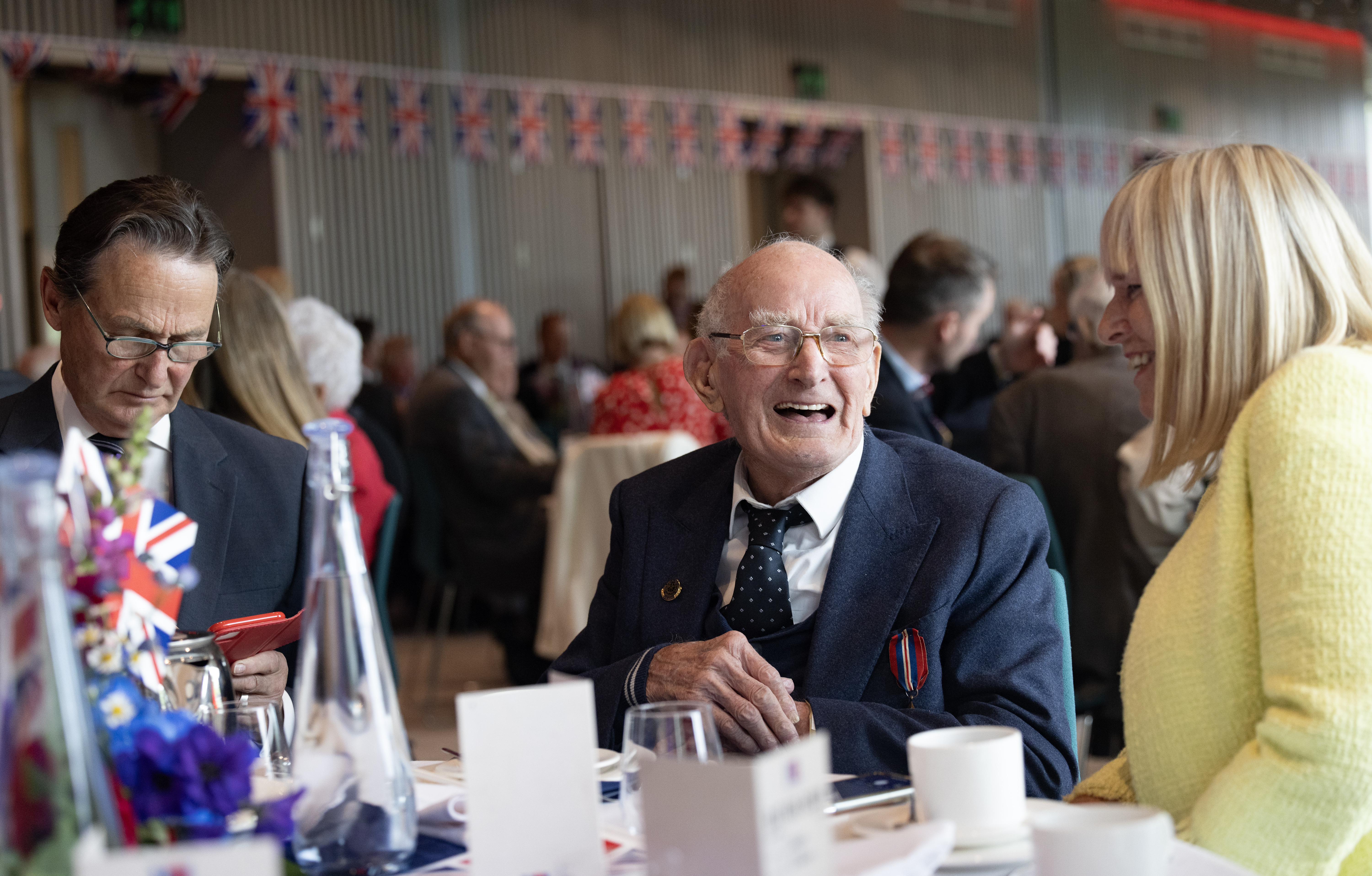 A Second World War campaign veteran talks animatedly to a member of his family
