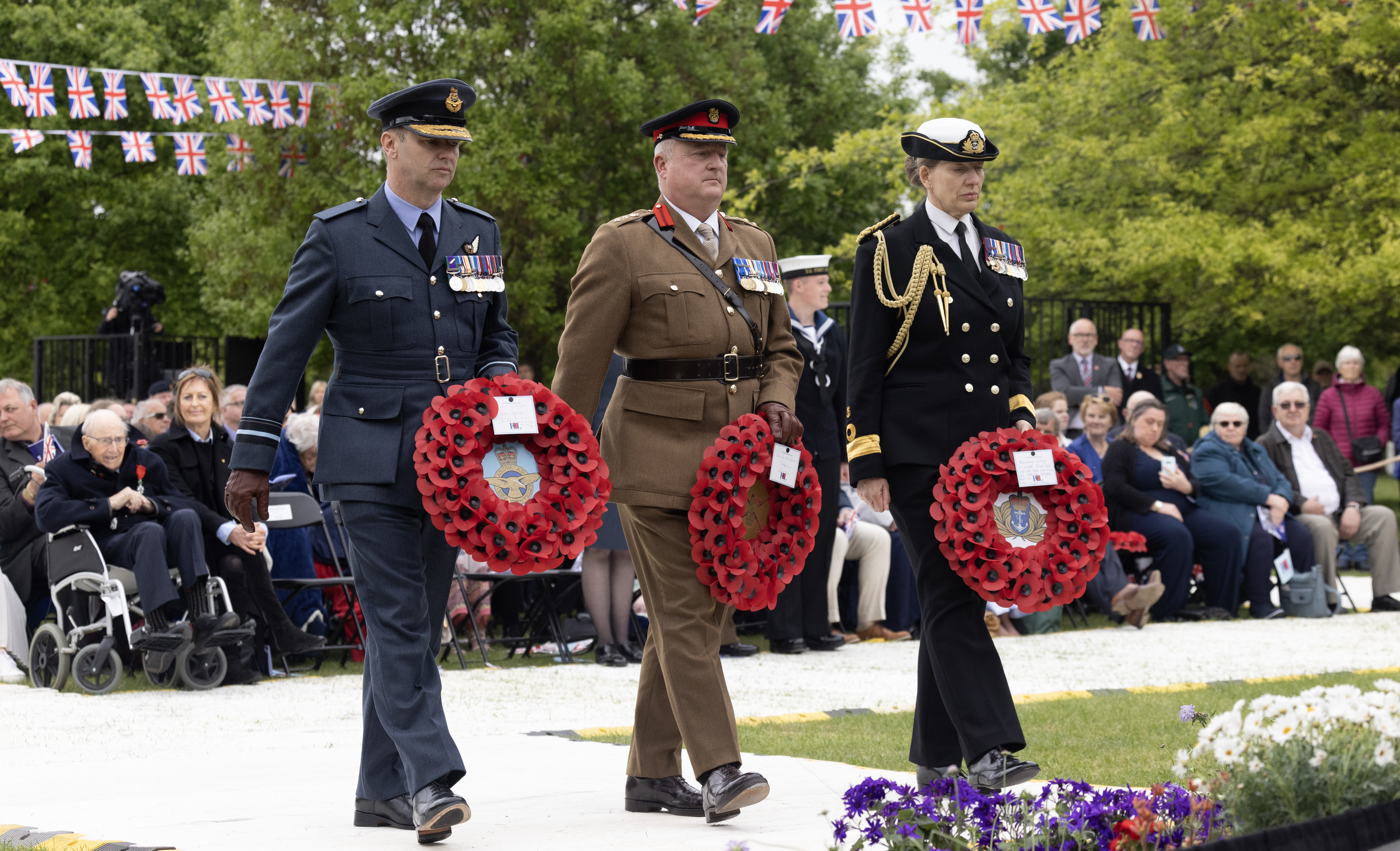 Represenatives from the Army, Navy and Army lay poppy wreaths at the VE Day 80 Remembrance Service