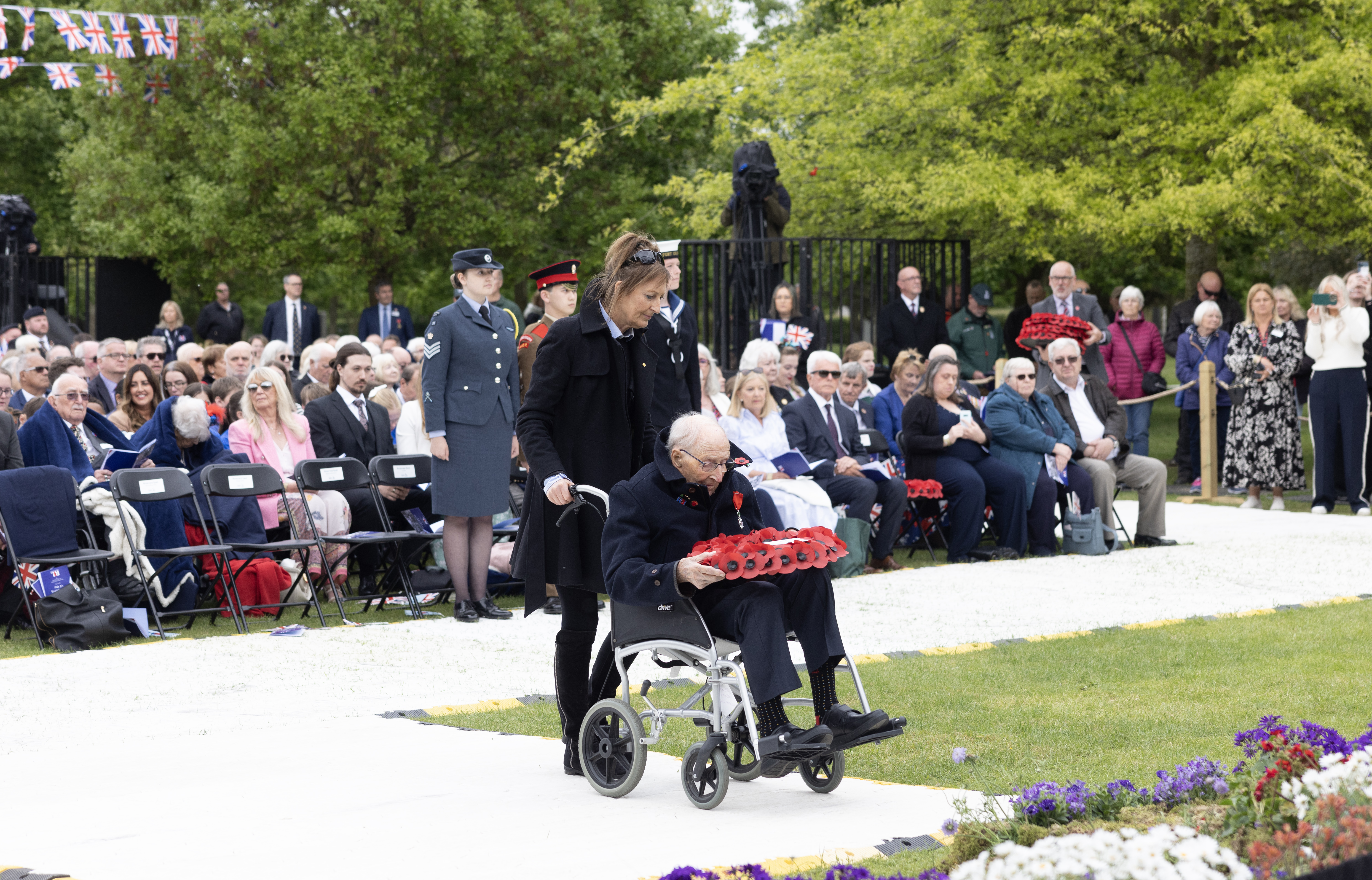 A Second World war campaign veteran lays a poppy wreath during the RBL 80 service