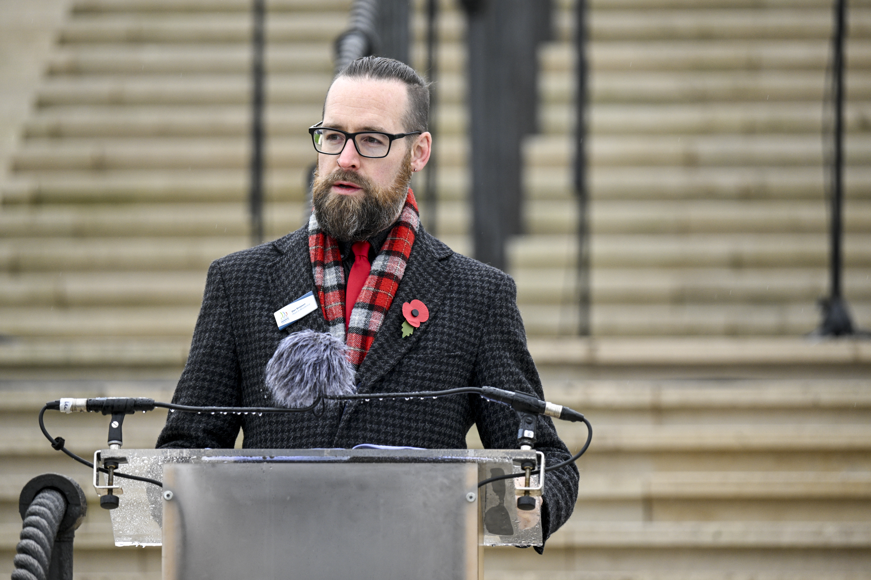Dan Simpson performing poetry at the Remembrance Sunday service in 2024.