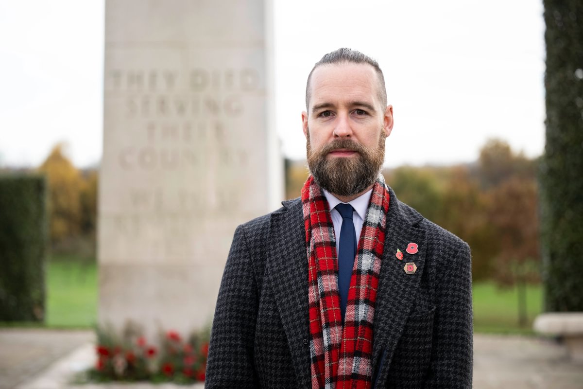 Dan Simpson, poet-in-residence in 2024, poses on the Armed Forces Memorial