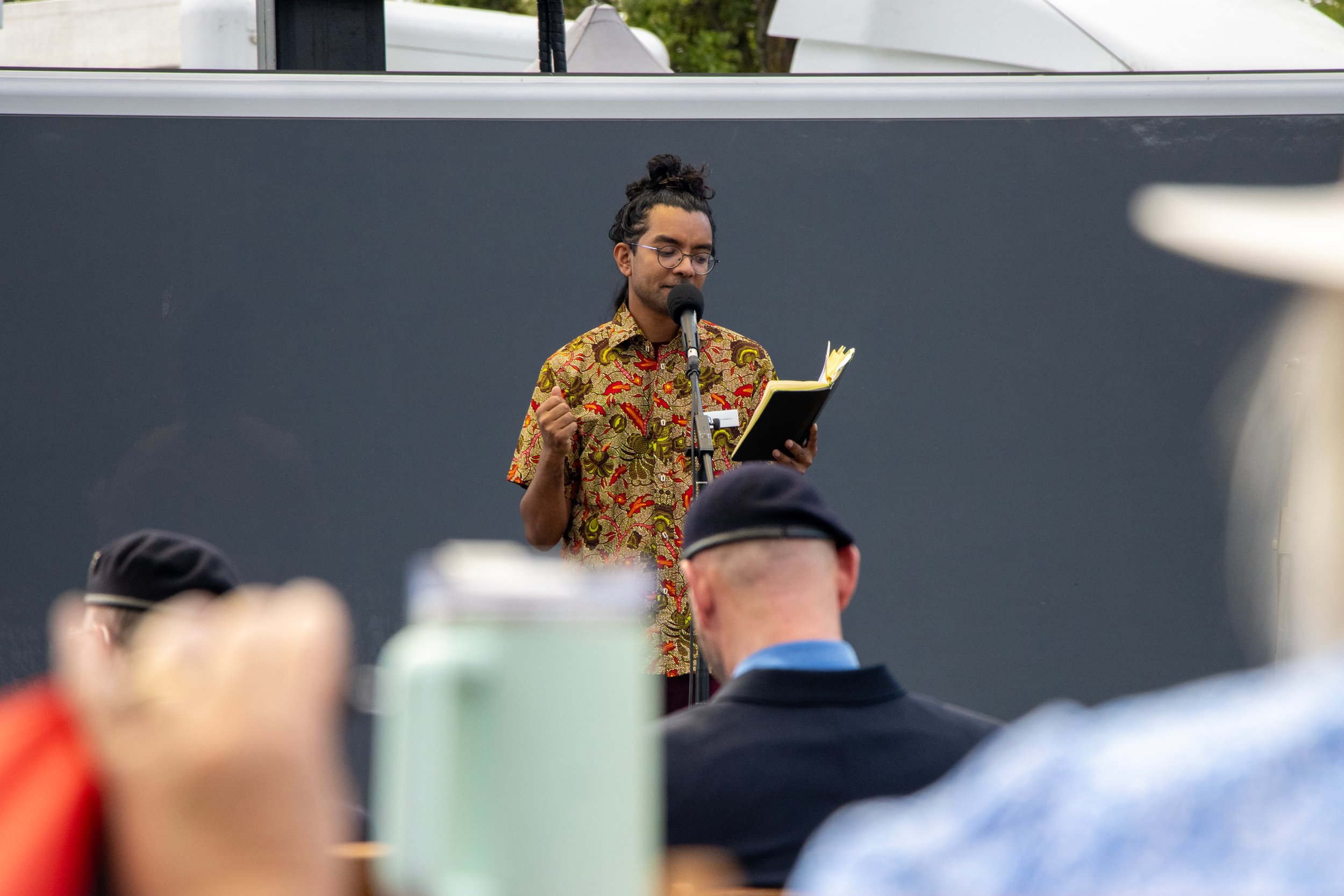 Arji performing poetry at the VJ Day 80 public service on the Naval Review, in 2026.