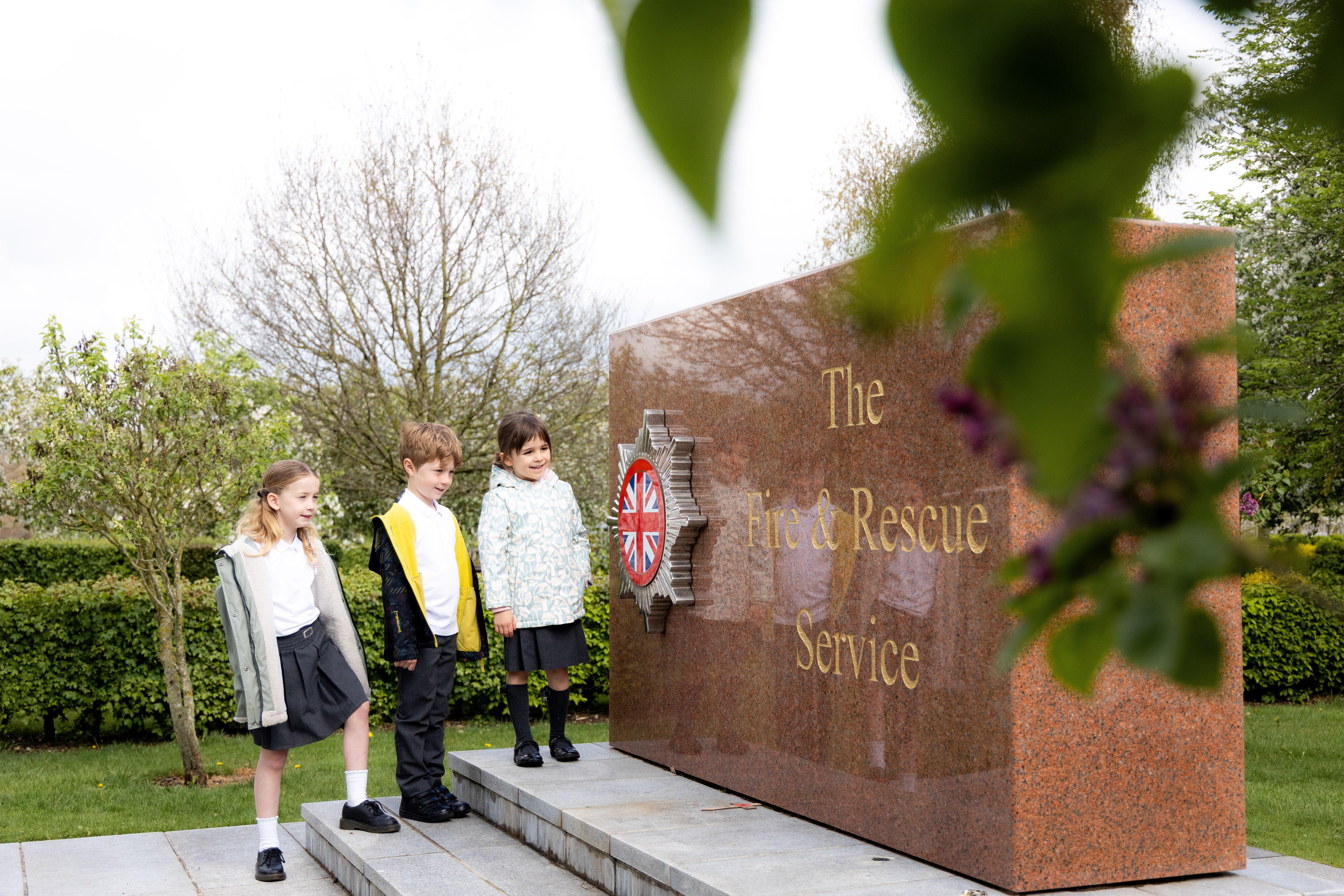 Key stage one pupils looking at the Fire and Rescue Services Memorial