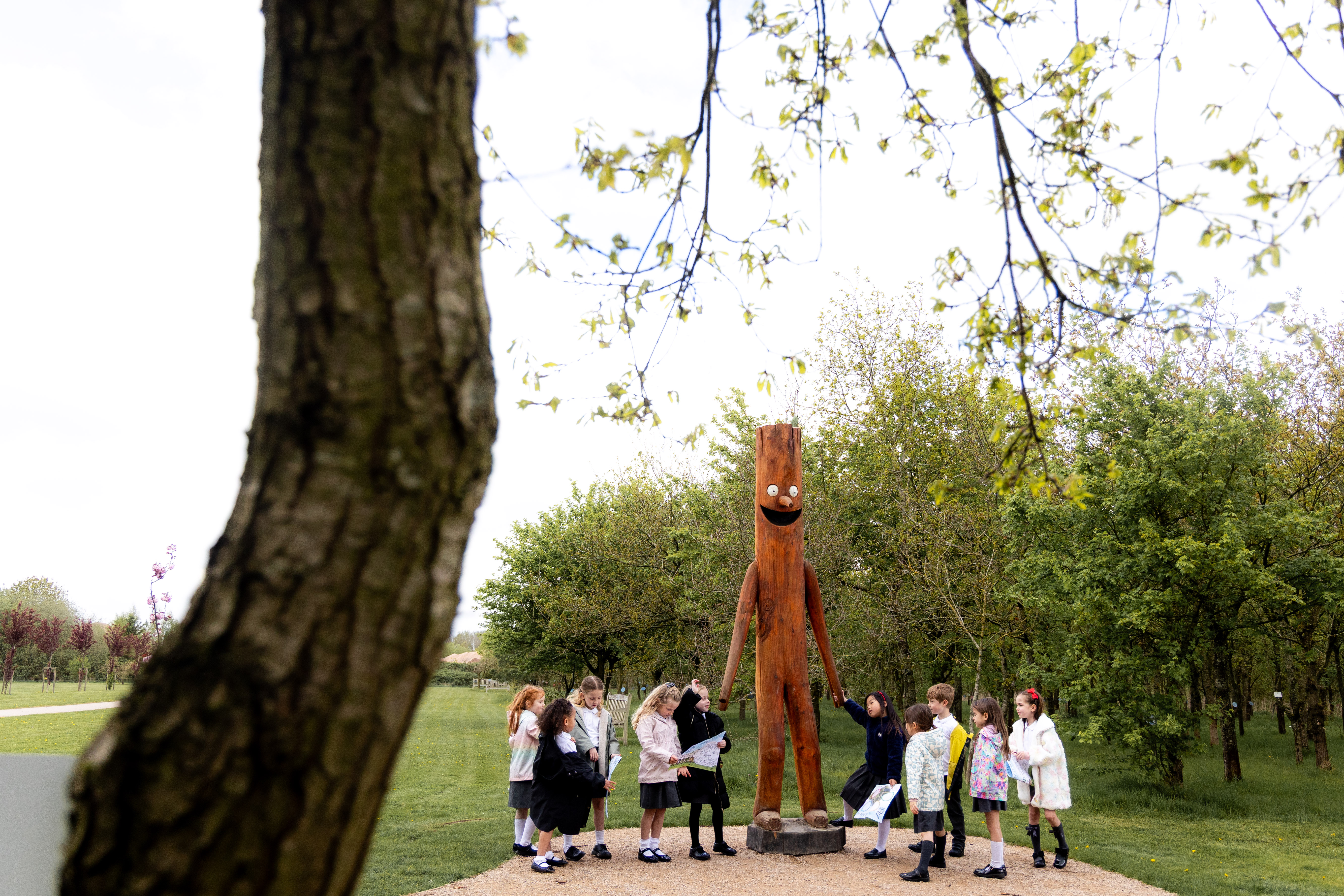 Key Stage One visiting Stick Man at the National Remembrance Gardens, holding his hand