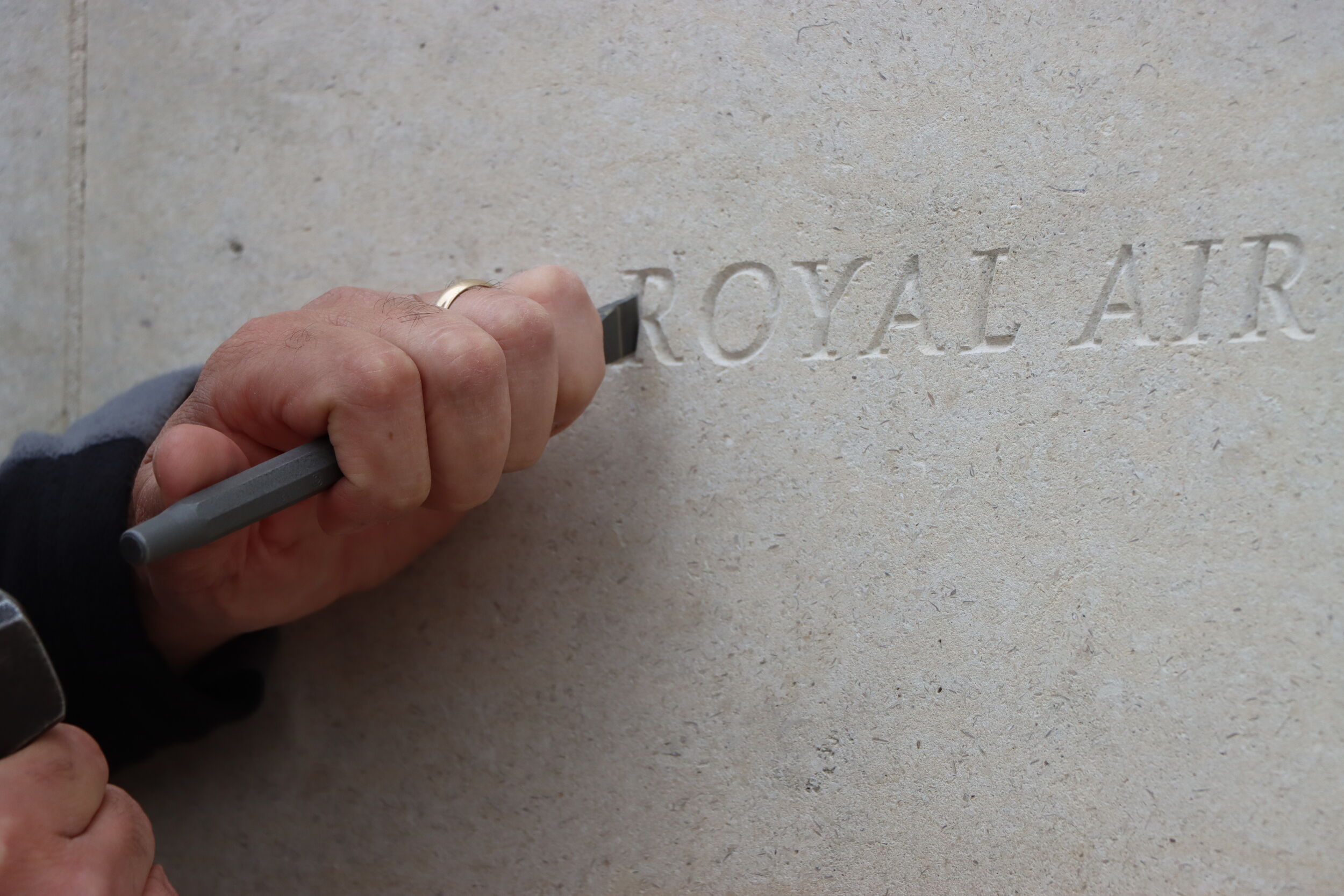 Stonemason Nick Hindle carving into the walls of the Armed Forces Memoiral