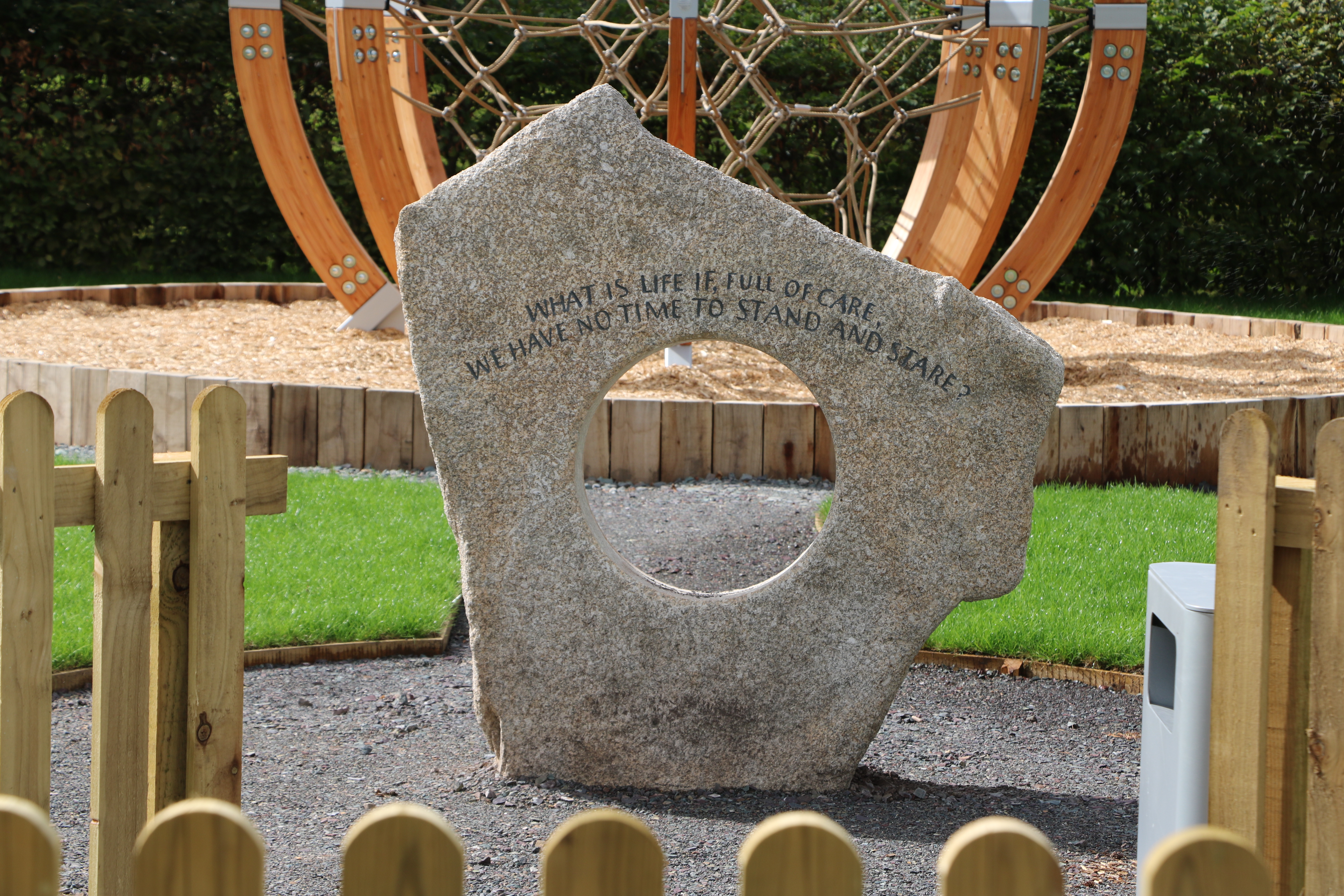 Children's Sensory Play Garden entrance featuring a line of poetry etched into rock.