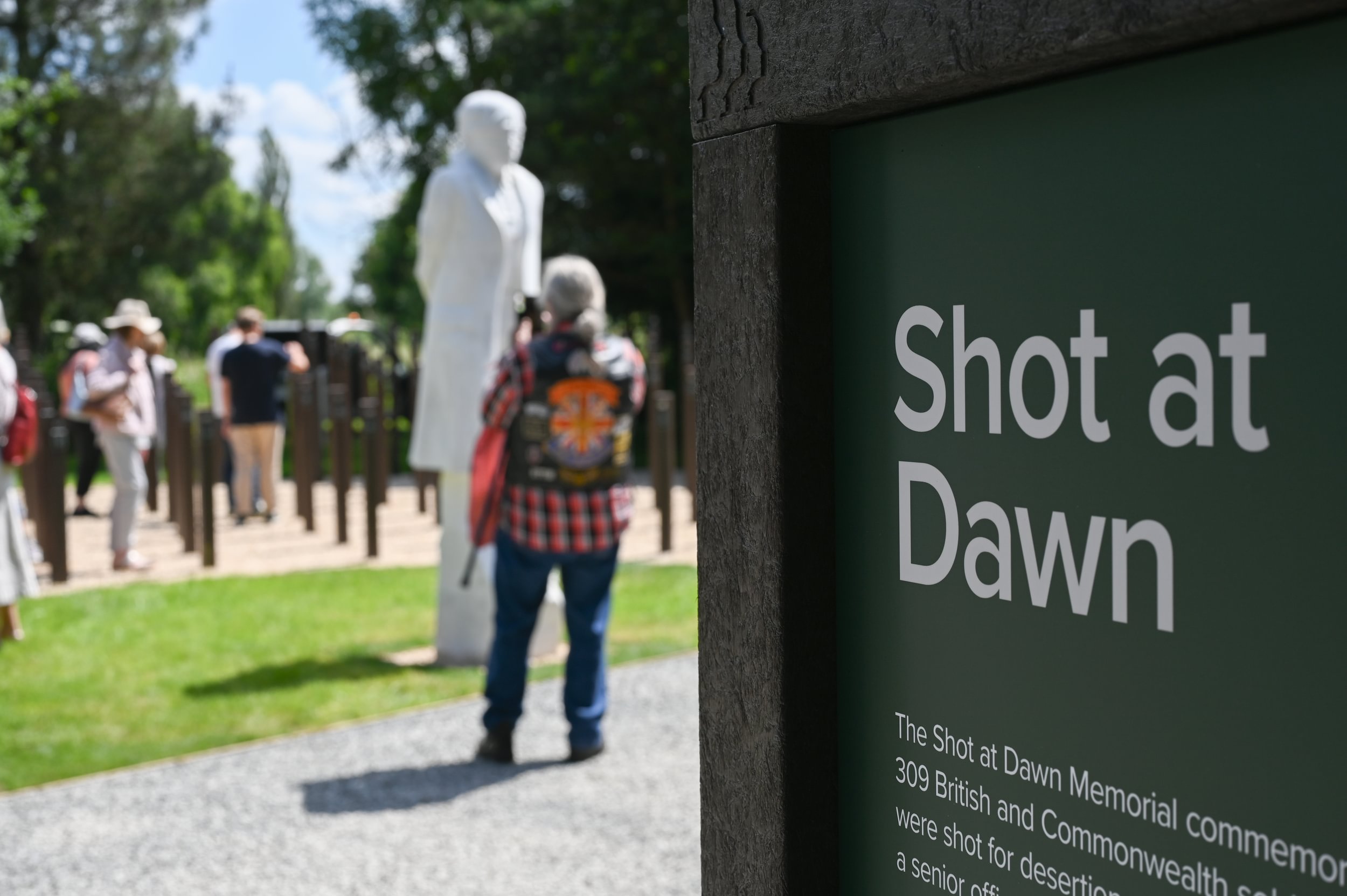 Visitor taking photographs of the Shot at Dawn Memorial