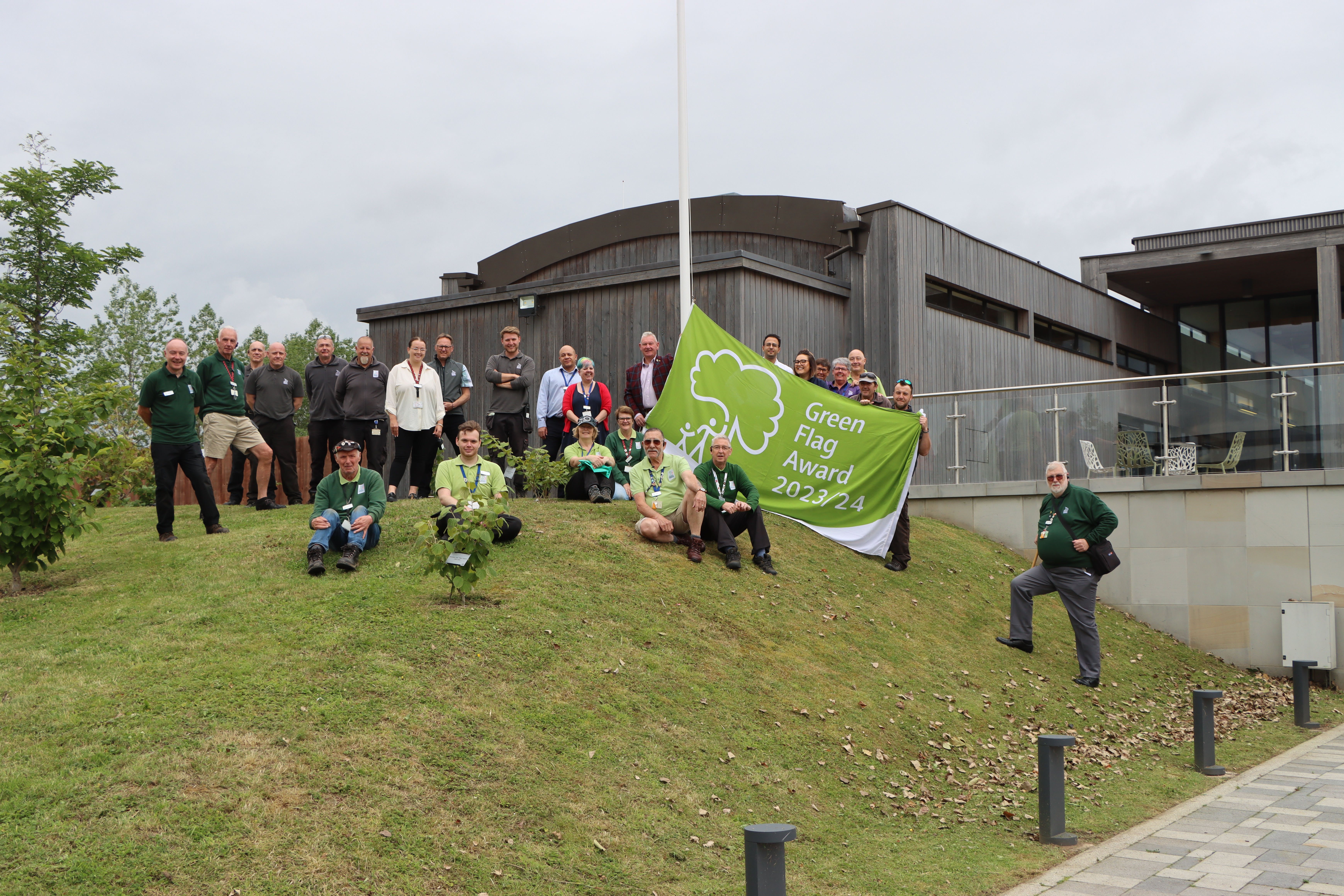 Arboretum Team holding the 2023 Green Flag within the Arboretum grounds