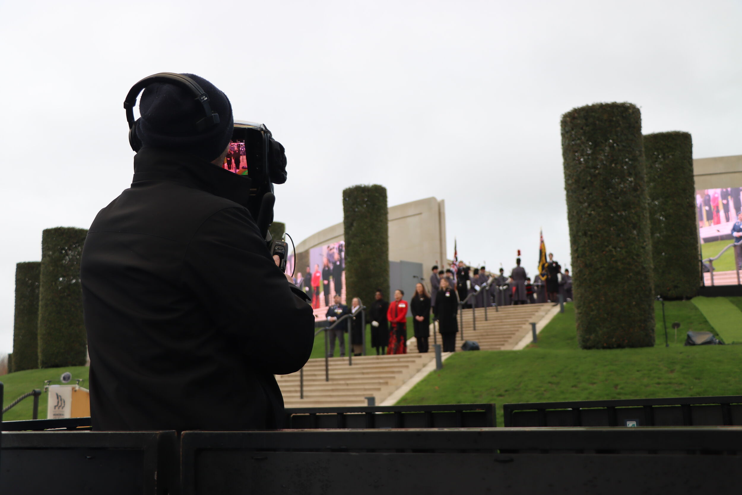 A camera man films a service on the Armed Forces Memorial
