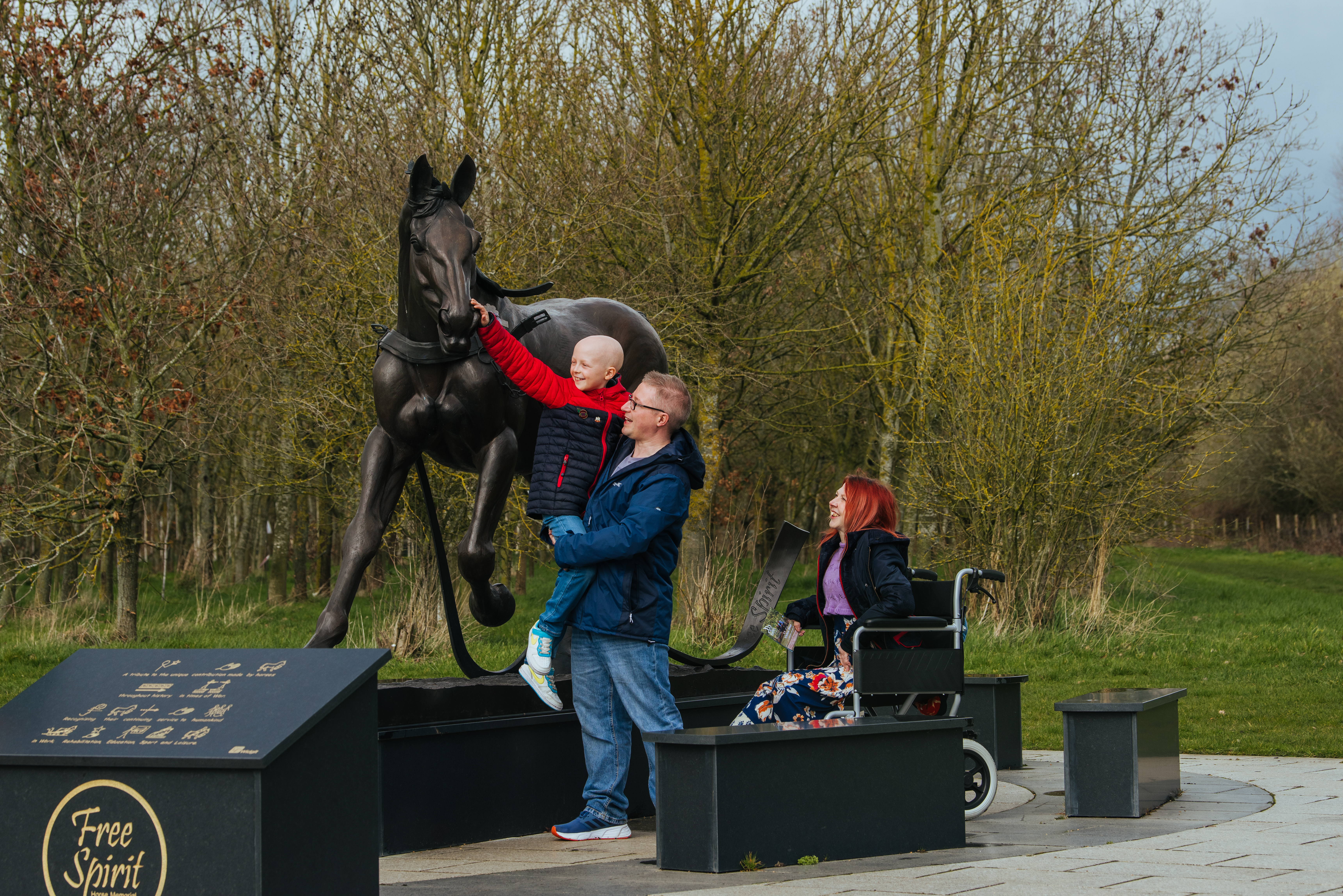 Family exploring one of the many memorials at the Gardens
