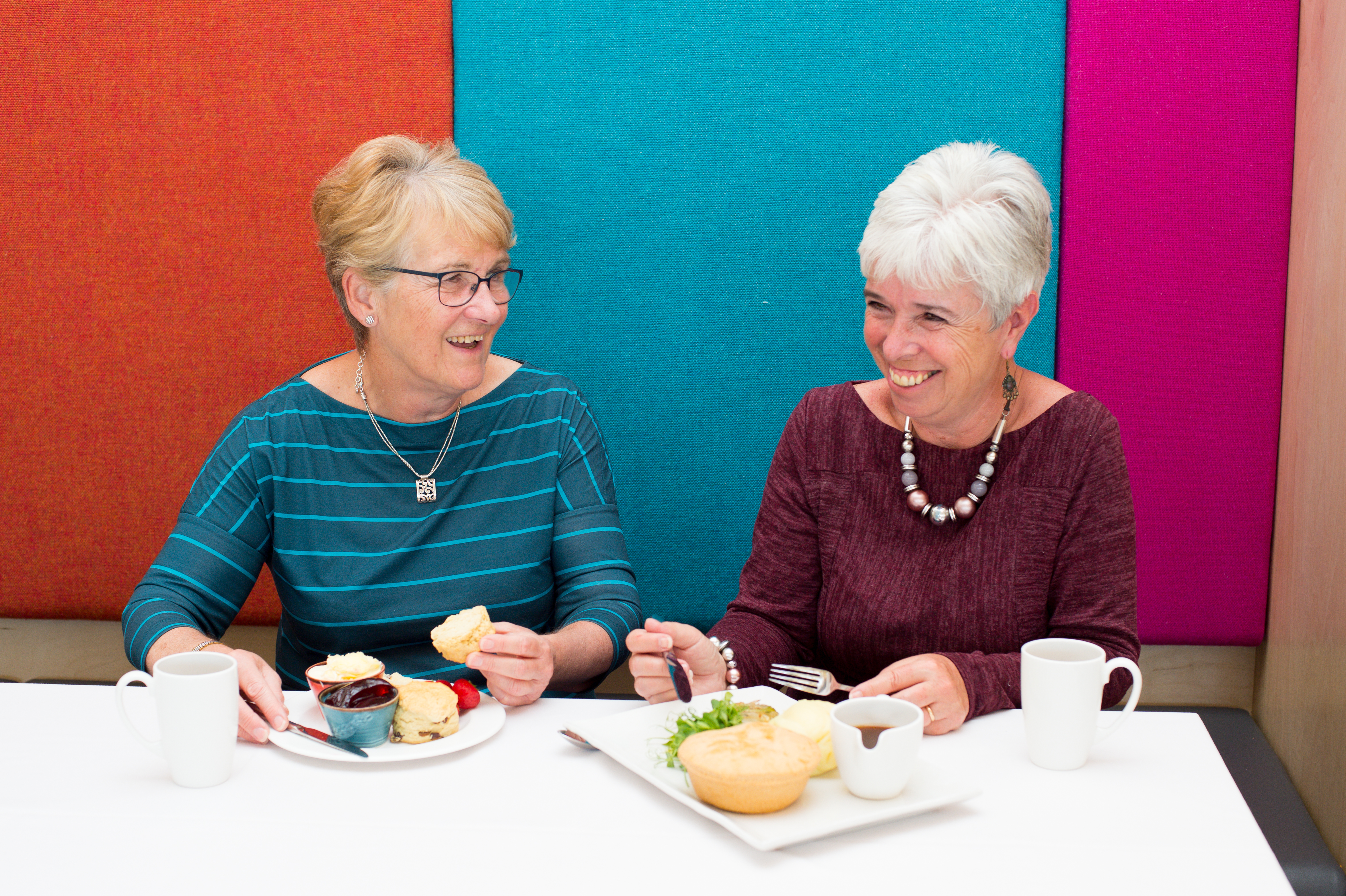 Two visitors enjoy a cream tea and pie meal in the restuarant