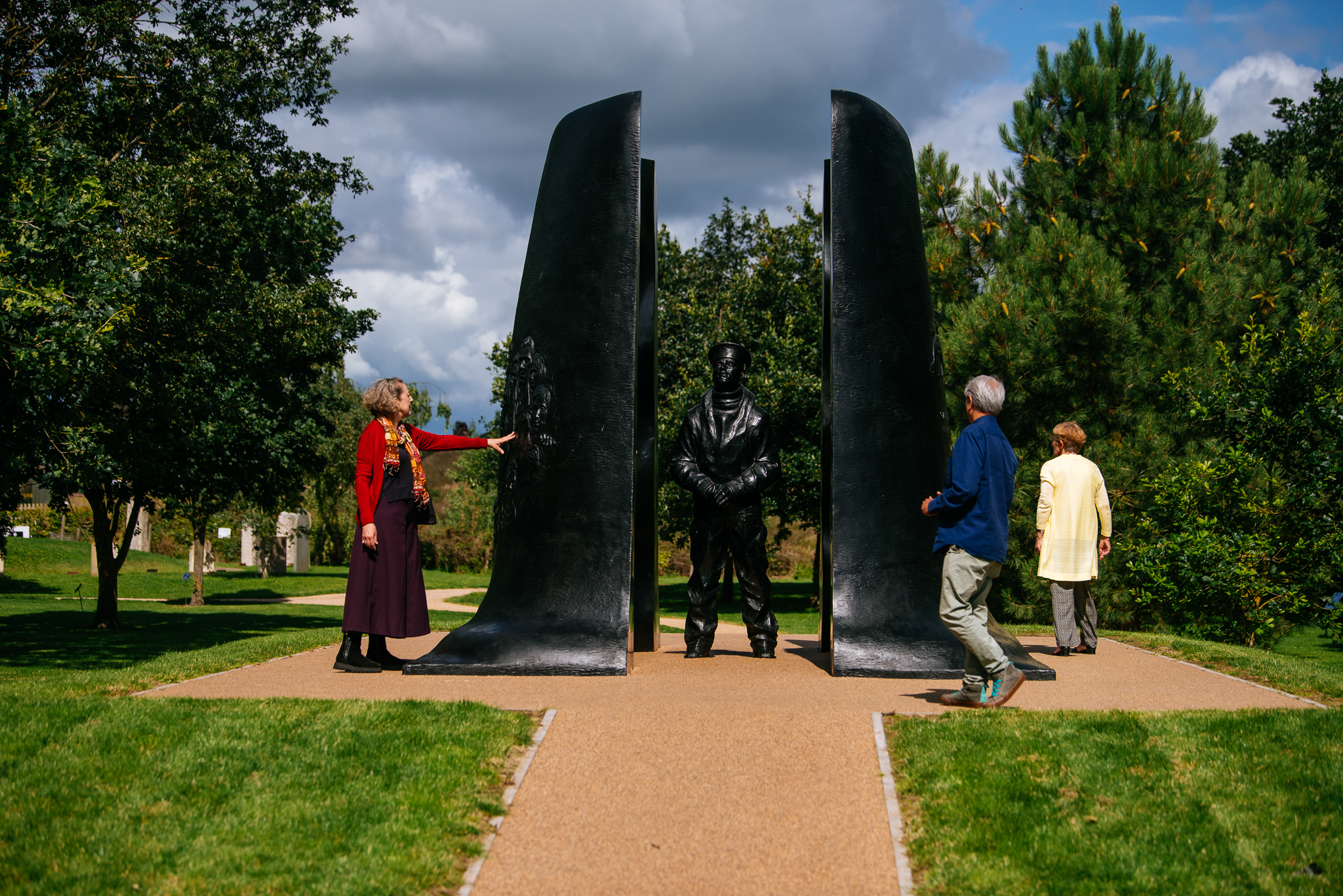 A group of people looking at the Submariners Memorial