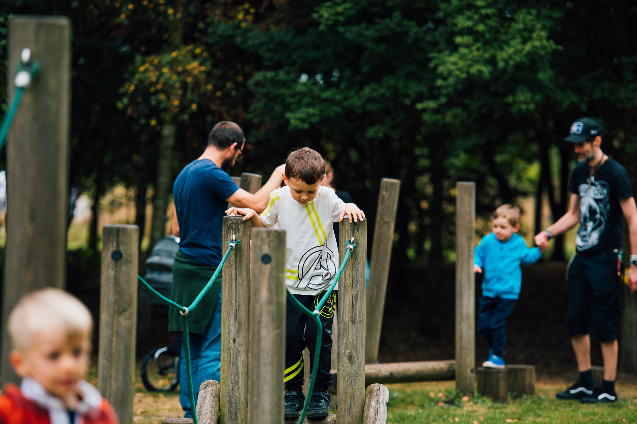 Children using the wooden climbing equipment in the Children's outdoor play area