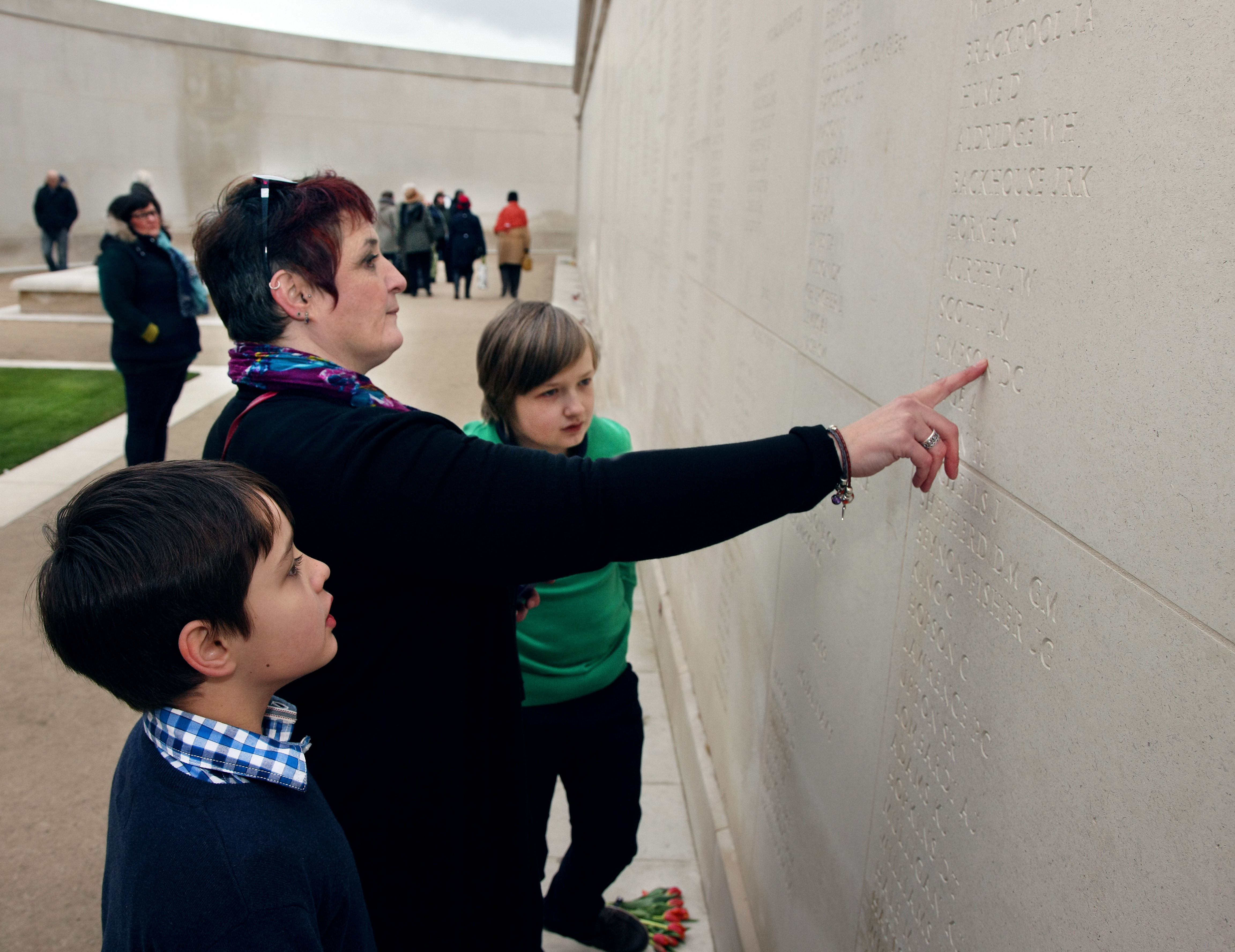 Lucy points at her sons name on the Armed Forces Memorial