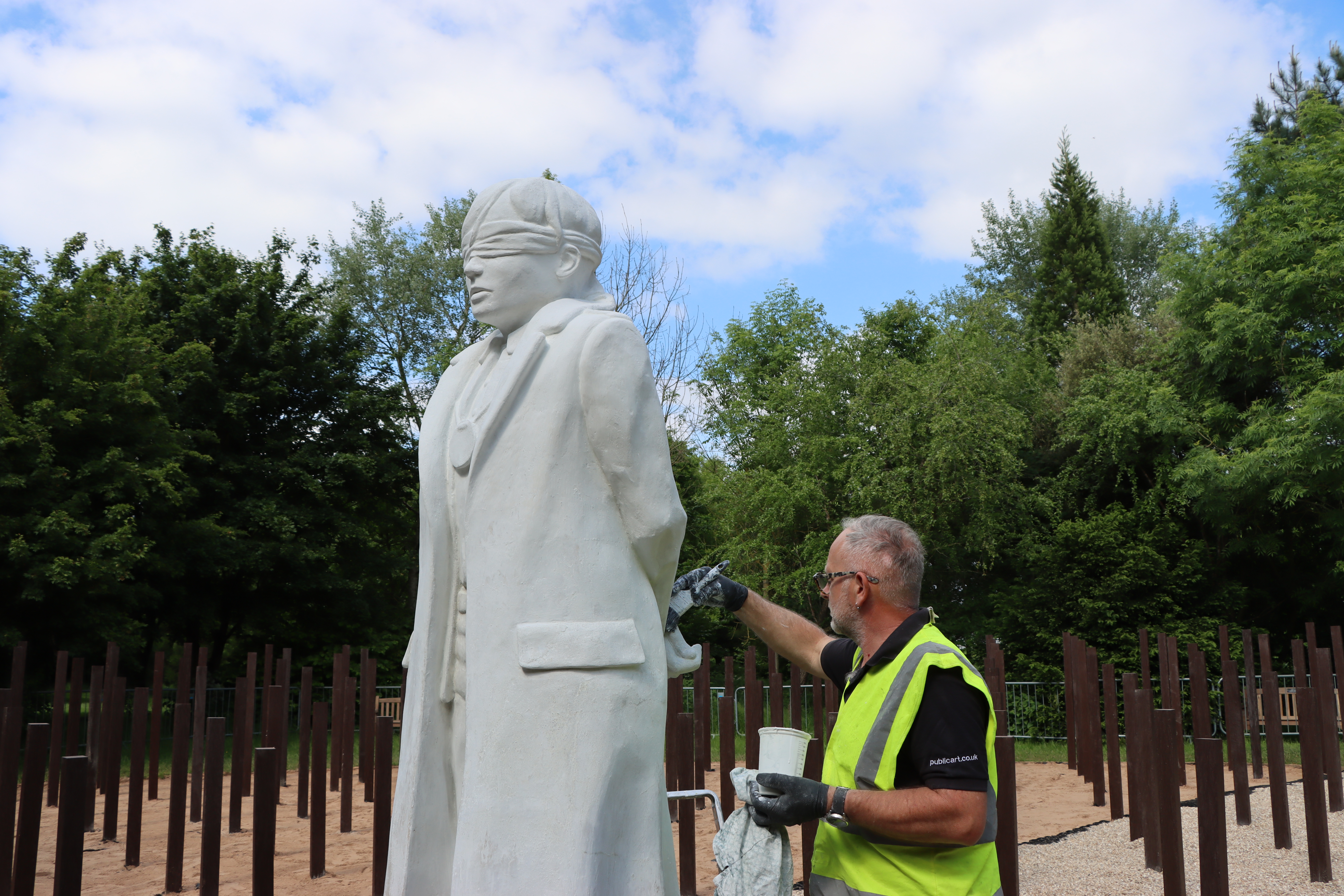 A volunteer helping to refurbish the statue, part of the Shot at Dawn Memorial